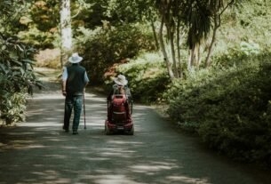 a man and a woman walking down a dirt road