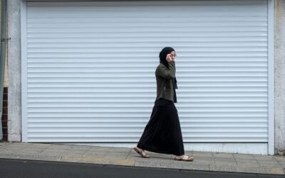 woman walking beside closed roll-up door