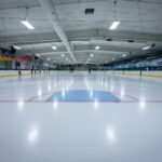 an indoor ice rink with a hockey goal