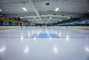 an indoor ice rink with a hockey goal