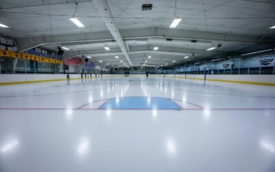 an indoor ice rink with a hockey goal