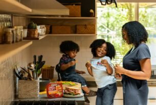 woman in white t-shirt standing beside woman in black and white stripe shirt