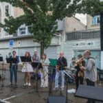 A group of people playing music on a street