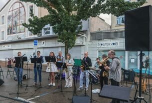 A group of people playing music on a street