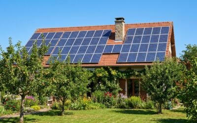 Toit de maison individuelle française avec panneaux solaires photovoltaïques, ciel dégagé, jardin