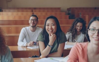 Students smiling in a lecture hall classroom
